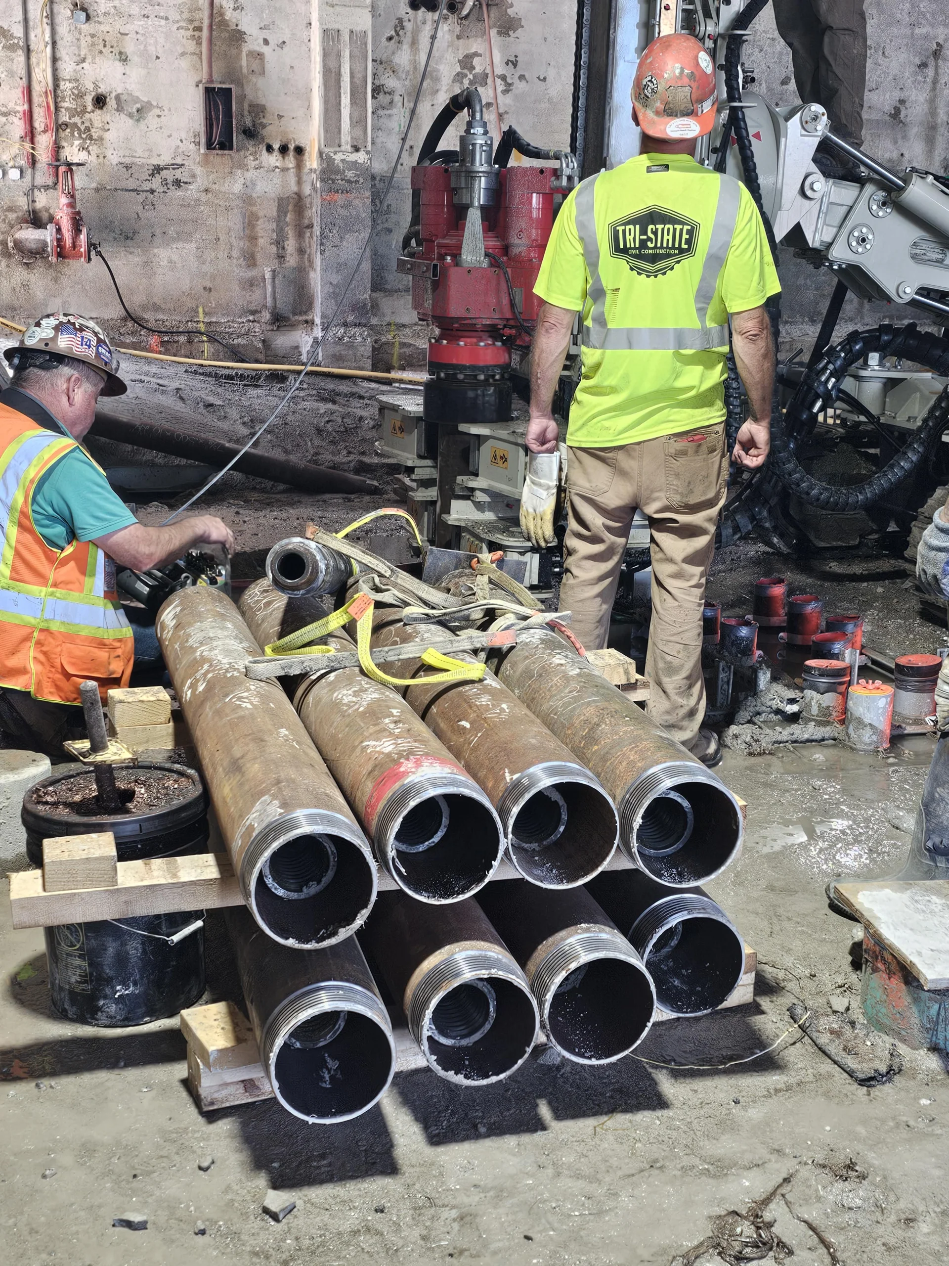 Tri-State worker with stack of large pipes