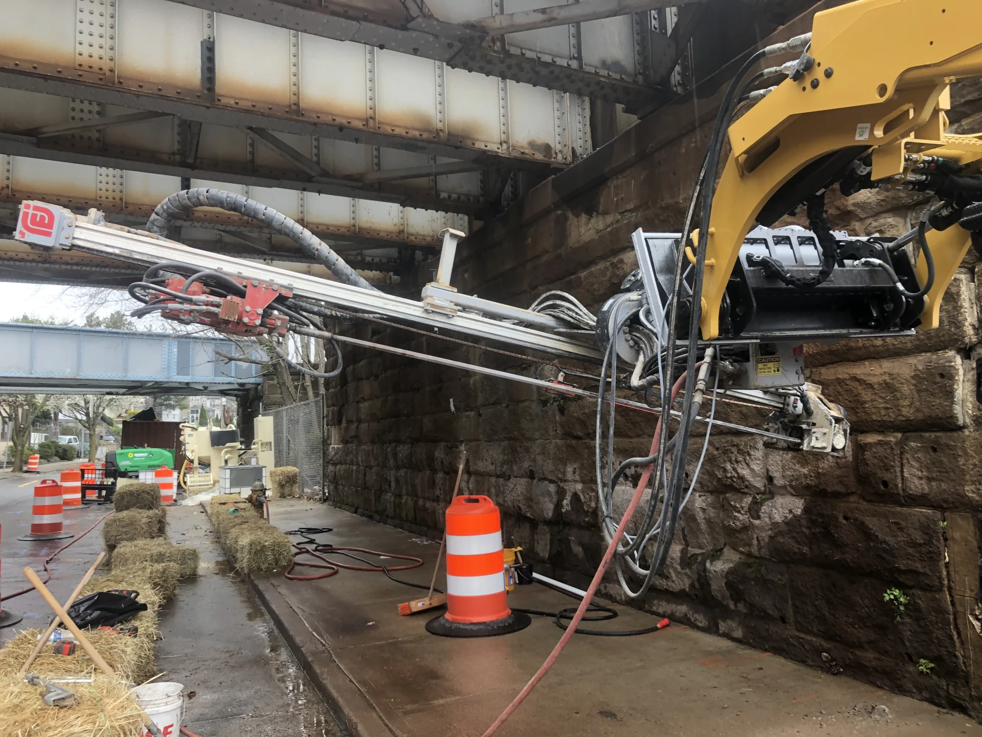construction equipment working on stone bridge supports