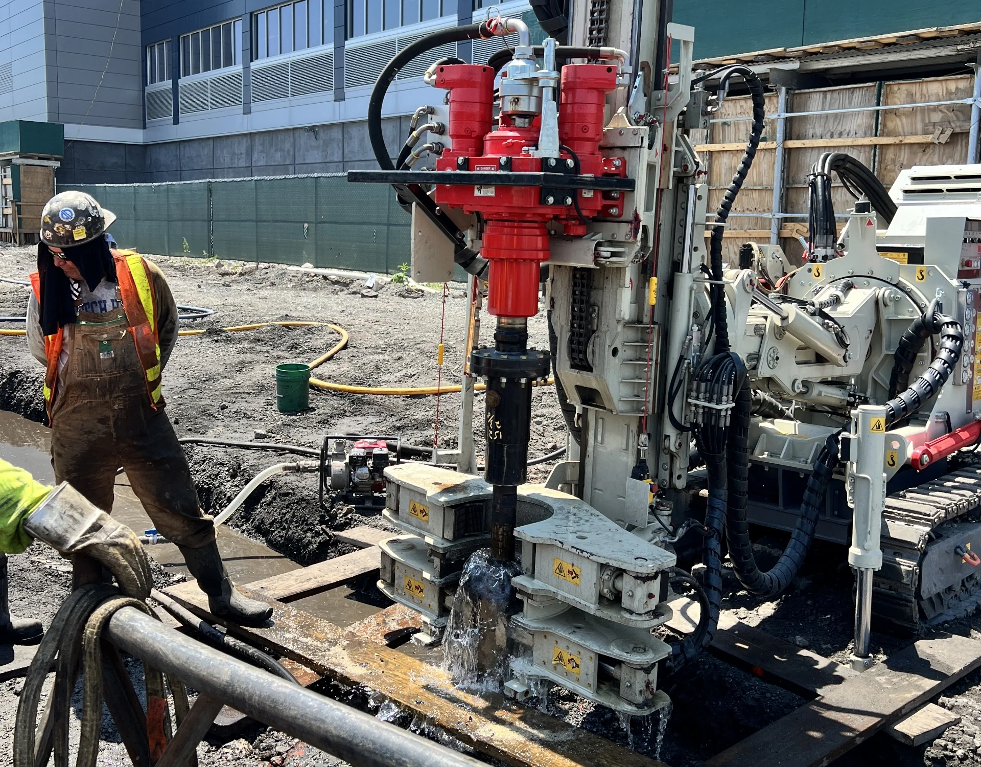 construction workers using drilling equipment