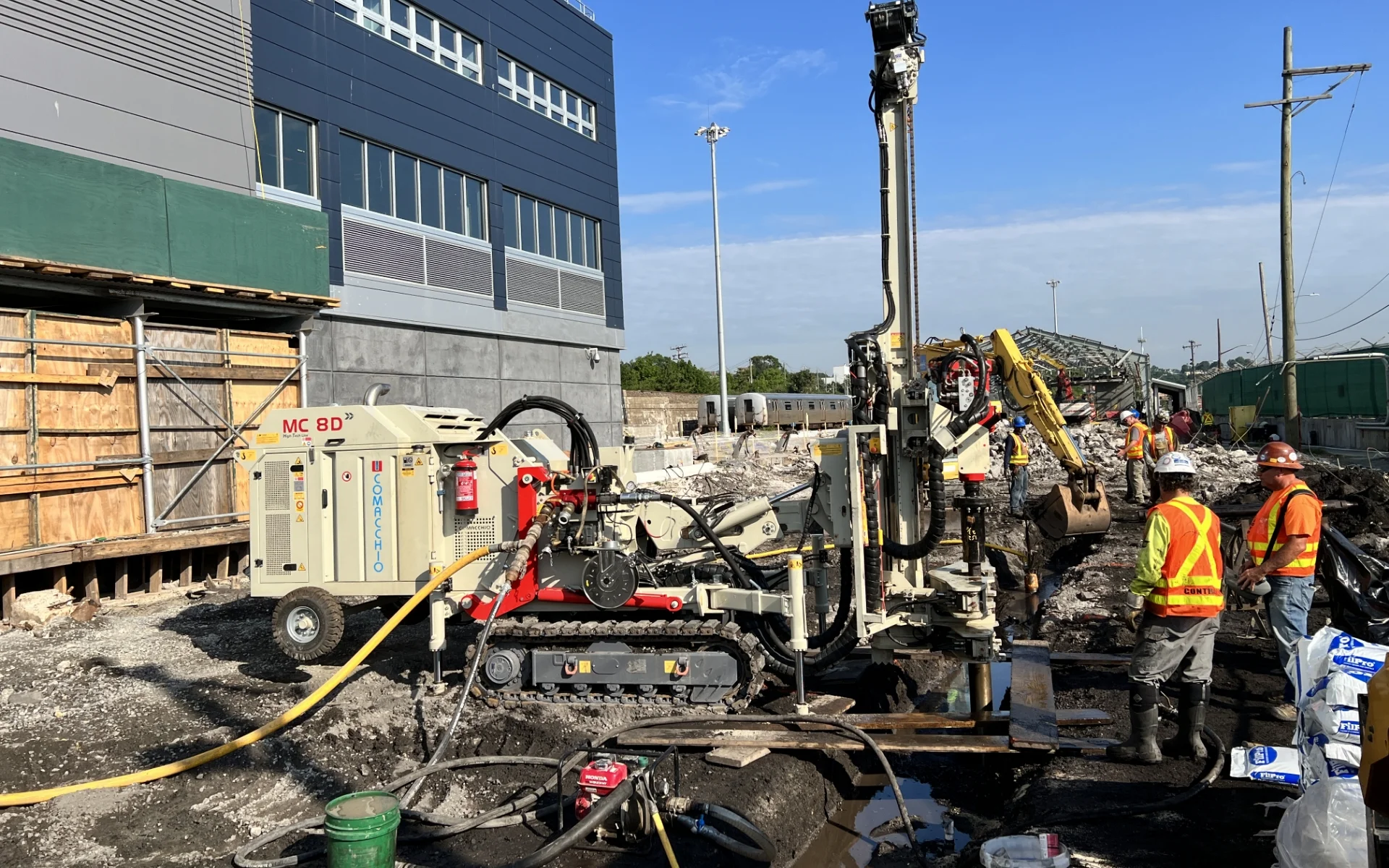 construction workers using drilling equipment